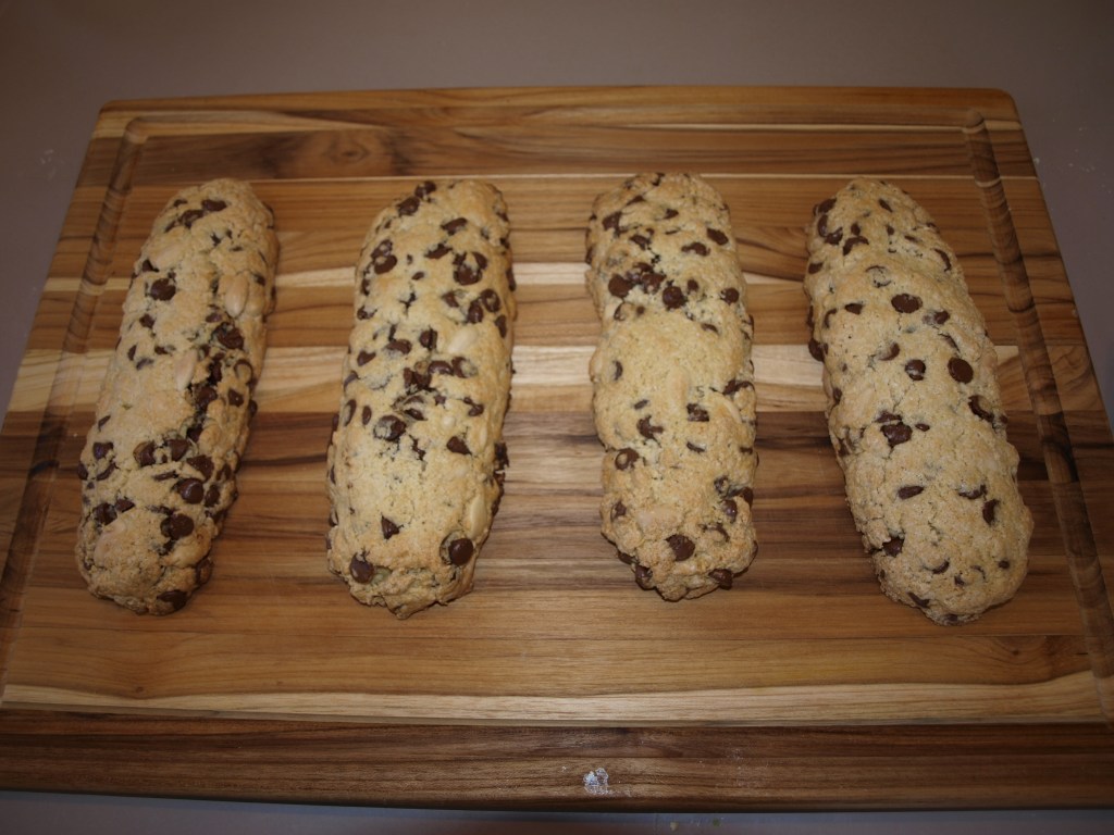 The biscotti mounds are cooling after the first round of baking. The dough is still somewhat soft to the touch at this point.